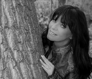 female posing by tree black and white photo