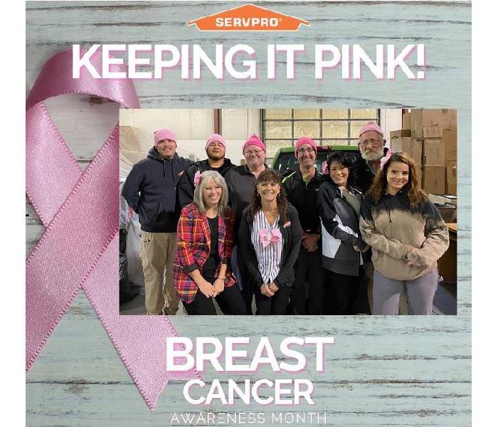 SERVPRO team members sporting pink hats and bows to support Breast Cancer Awareness Month