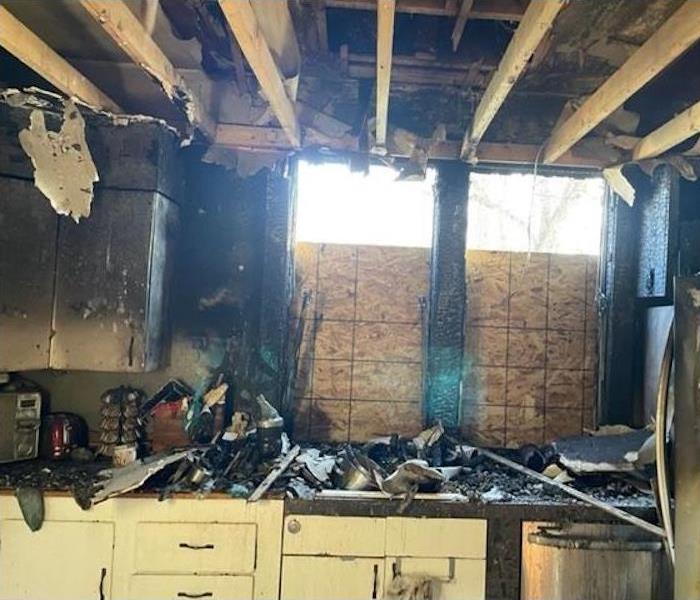 Kitchen window and ceiling damage after a fire