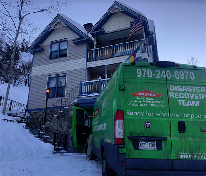 a SERVPRO vehicle parked in front of a house